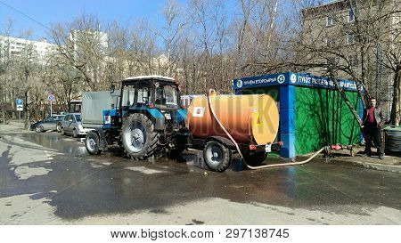 Moscow, Rf-2019, March, 17: Tractor With Tank Watering The Streets Of The City, The Barrel Is Orange