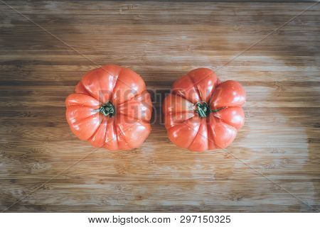 Oxheart Tomatoes. Tomatoes On A Bamboo Wood Plate.
