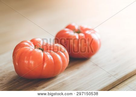 Oxheart Tomatoes. Tomatoes On A Bamboo Wood Plate.