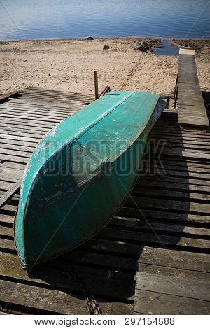 Boat On The Slopes In Anticipation Of The Arrival Of Water. Low Water Level In The River. Drought In