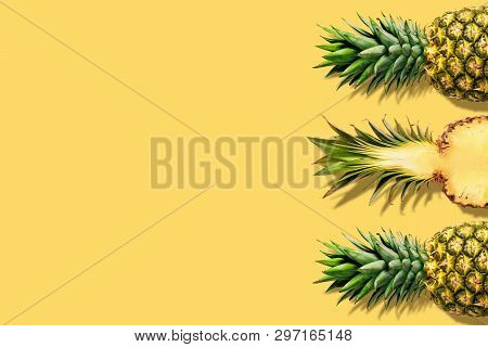 Fresh Pineapples On Yellow Background. Creative Suumer Concept.