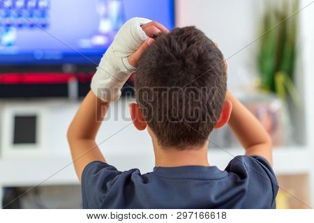 Anonymous Boy With Broken Arm Watching Tv