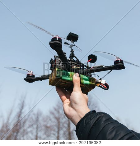Pilot Racing Drone Holds In His Hand Fpv Copter Before Launching It. A Small High-speed Aircraft Wit