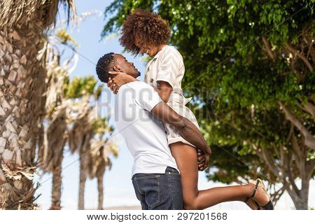 Outdoor Protrait Of Black African American Couple - Guy Carrying Girfriend On His Back