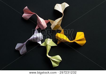 Handmade Paper Craft Origami Gold Koi Carp Fishes On Black Background.top View, Pattern