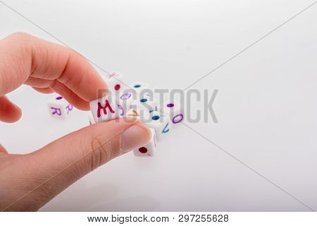 Colorful Alphabet Letter Cubes In Handon A White Background