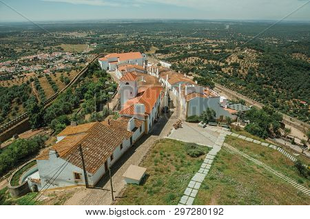 View Of The Small Village Main Street And Countryside Landscape With Green Hills At Evoramonte. A Ti
