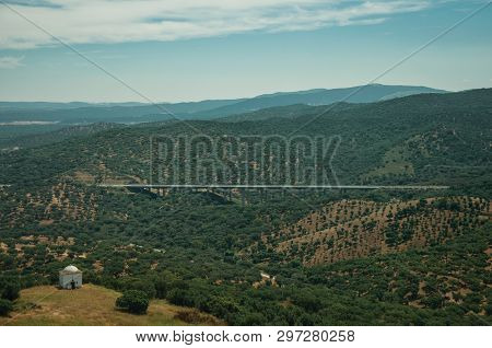 Countryside Landscape With Green Hills, Viaduct With Road And Small Chapel Near Evoramonte. A Tiny F