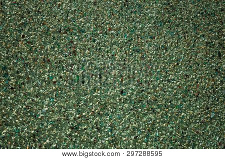 Close-up Of Plaster Wall With Small Gravel And Ceramic Pieces Inserted In It, Forming An Odd Backgro
