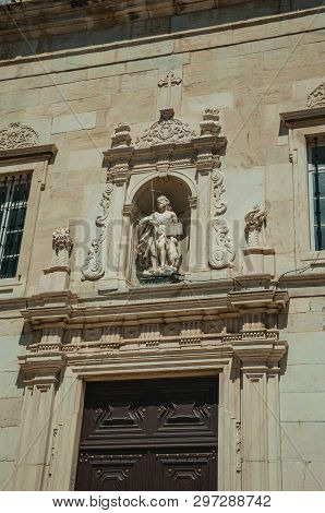Niche Sculpture Above The Entrance Door On Church Facade Carved In Marble, In A Sunny Day At Campo M