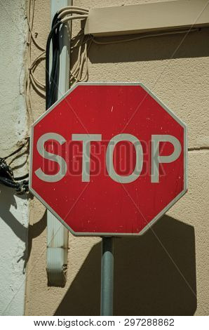 Close-up Of No Entry Road Sign In Front Of Beige And White Rough Plaster Wall, In A Sunny Day At Cam