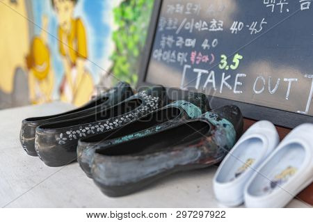 Jeonju, South Korea - September 2018: Pairs Of Shoes Decorated In Front Of A Cafe  In Jaman Mural Vi