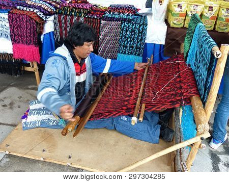 Cuenca, Ecuador - April 14, 2017: Ecuadorian Man Is Weaving Scarf Or Macana By Hand With Cotton Thre