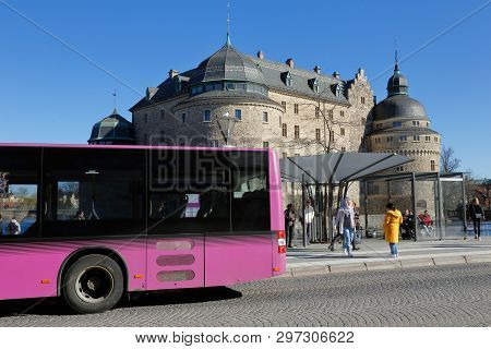 Orebro, Sweden - April 17, 2019: One Violet Public Transportation City Bus In Front Of The Orebro Ca