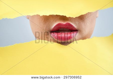 Full Pink Lips Of Woman Between Thorn Yellow Paper Sheets