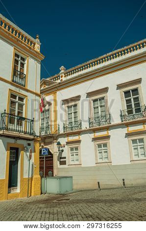Elvas, Portugal - July 7, 2018. Empty alley with facades of old colorful houses at Elvas. A gracious star-shaped fortress city on the easternmost frontier of Portugal.
