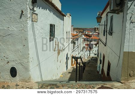 Campo Maior, Portugal - July 8, 2018. Alley Going Down The Slope With Steps Among Old Houses At Camp