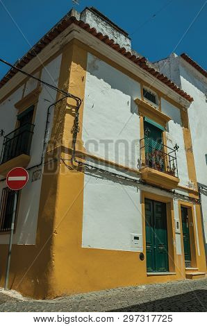 Campo Maior, Portugal - July 8, 2018. Stop Road Sign In Front Colorful House In A Street Of Campo Ma