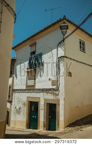 Castelo De Vide, Portugal - July 10, 2018. Old Houses In Cobblestone Alley On Slope At Castelo De Vi