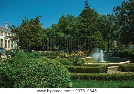 Castelo De Vide, Portugal - July 10, 2018. Green Bushes In A Wooden Garden With Fountain At Castelo 