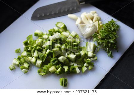 Chopped Ridge Gourd, Turai Or Dodka, On A Chopping Board With A Knife