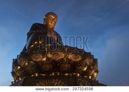 Buddha Statue On Top At Sunset In The Clouds. Big Buddha Statue At The Top Of Fansipan Mountain, Sap