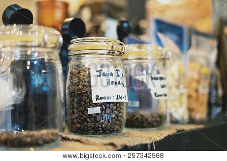 Coffee Bean In Glass Jar. Arabica Coffee Variant Java Ijen Raung With Honey Process And Roast In Gla