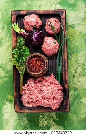 Raw Meatballs On A Chopping Board