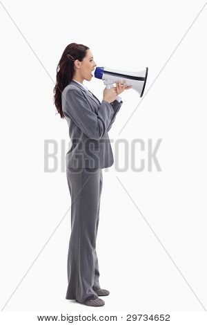 Profile of a businesswoman speaking loudly in a megaphone against white background