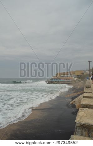 Pool Of A Hotel At The End Of The Photo On A Cloudy Day At Playa Grande In Colares. Nature, Architec