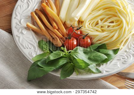 Various Types Of Cheese In A Bowl With Basil And Cherry Tomatoes - Cheese Chechil, Straws, Smoked Ch