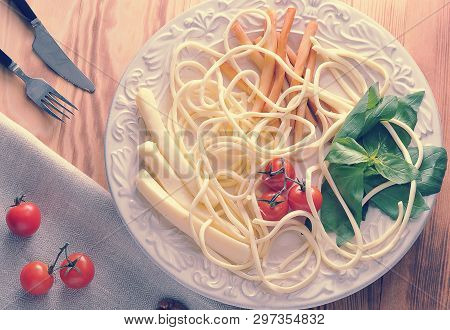 Various Types Of Cheese In A Bowl With Basil And Cherry Tomatoes - Cheese Chechil, Straws, Smoked Ch