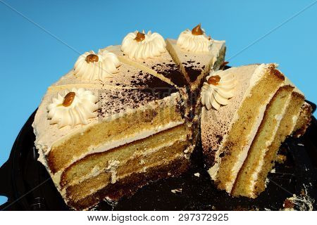 Five Servings Of Caramel Biscuit Cake On A Brown Substrate. Background - Blue