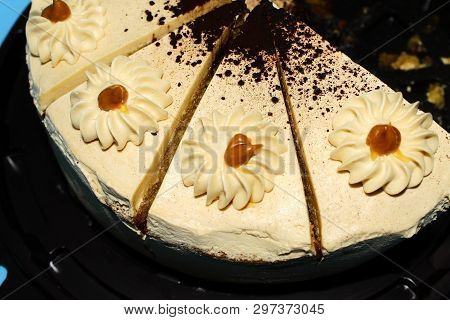 Four Pieces Of Sweet Biscuit Caramel Cake On A Brown Substrate. Blue Background