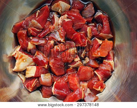 Raw Beef Chopped In Metallic Bowl. Cooking Engredients For Braised Beef Meat Stew. Close Up View