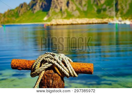 Harbor Marina Detail. Old Rusty Mooring Bollard With Rope. Bleik Village, Andoya Island, Vesteralen 