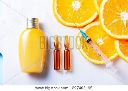 Vitamin C, Natural Anti Aging Cosmetics Cream And Serum Ampula On White Table