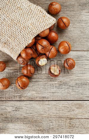 Macadamia Nut On A Wooden Table In A Bag, Closeup, Top View