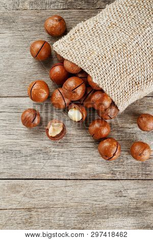 Macadamia Nut On A Wooden Table In A Bag, Closeup, Top View