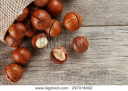 Macadamia Nut On A Wooden Table In A Bag, Closeup, Top View