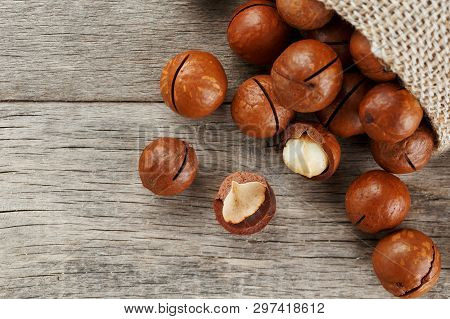 Macadamia Nut On A Wooden Table In A Bag, Closeup, Top View