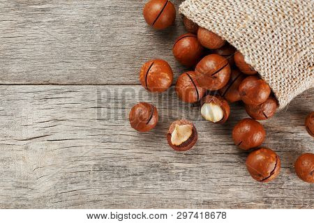 Macadamia Nut On A Wooden Table In A Bag, Closeup, Top View