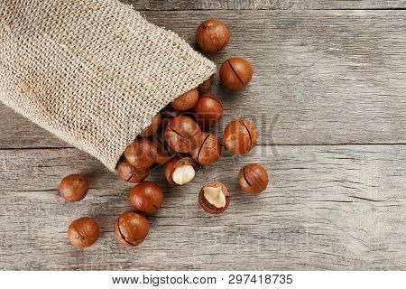 Macadamia Nut On A Wooden Table In A Bag, Closeup, Top View