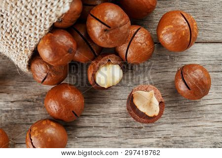 Macadamia Nut On A Wooden Table In A Bag, Closeup, Top View