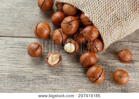 Macadamia Nut On A Wooden Table In A Bag, Closeup, Top View