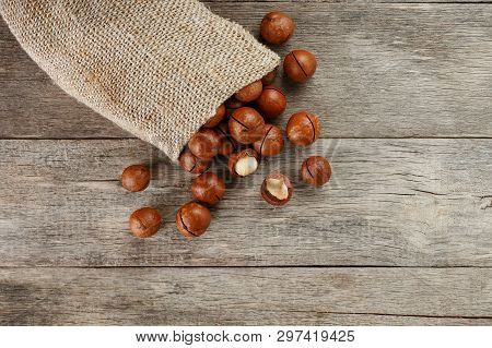 Macadamia Nut On A Wooden Table In A Bag, Closeup, Top View