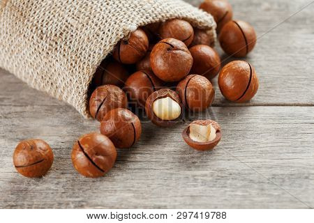 Macadamia Nut On A Wooden Table In A Bag, Closeup, Top View