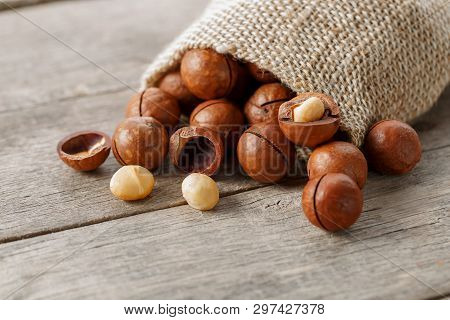 Macadamia Nut On A Wooden Table In A Bag, Closeup, Top View