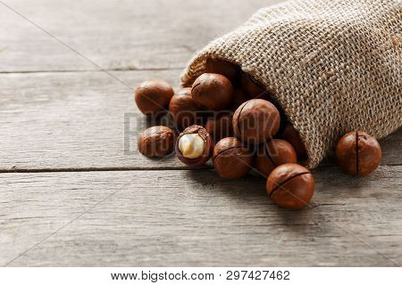 Macadamia Nut On A Wooden Table In A Bag, Closeup, Top View