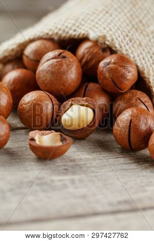 Macadamia Nut On A Wooden Table In A Bag, Closeup, Top View